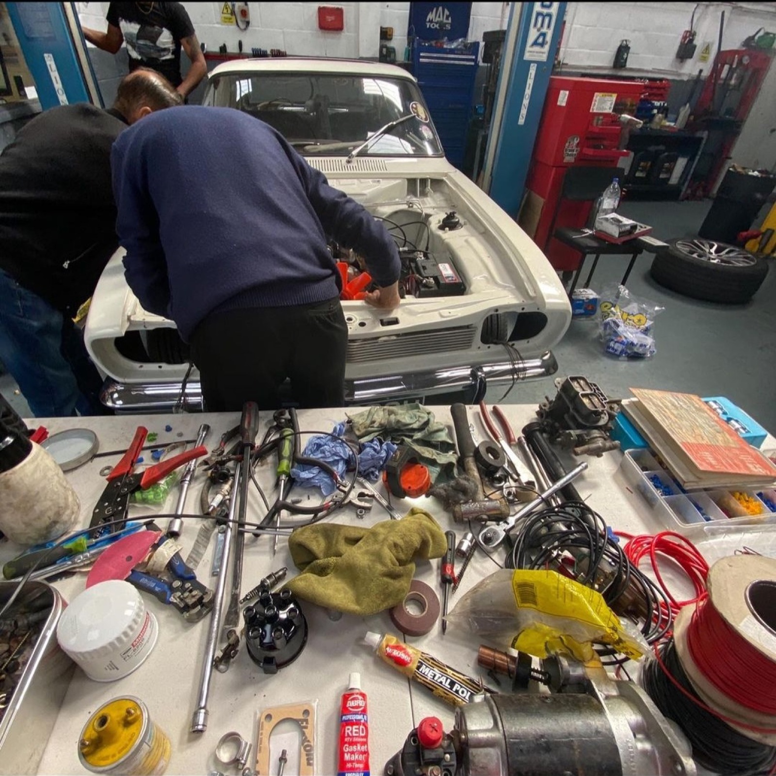 Gearbox and mechanical parts on the floor of the workshop at Southall MOT Services